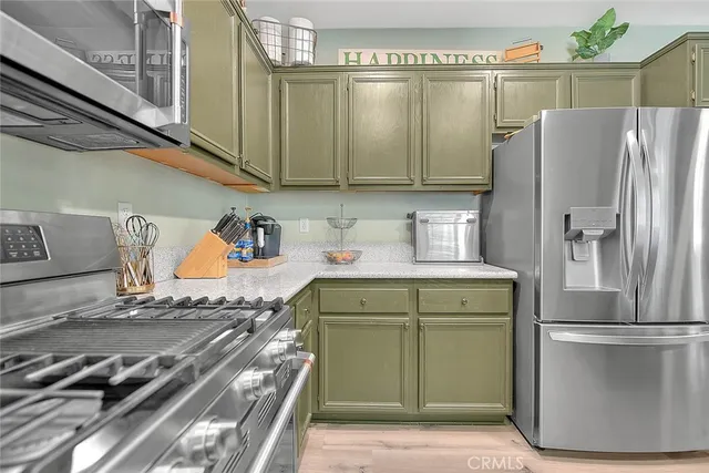 a kitchen with a refrigerator and a stove