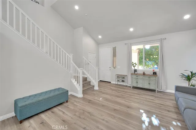a living room with furniture and stairs