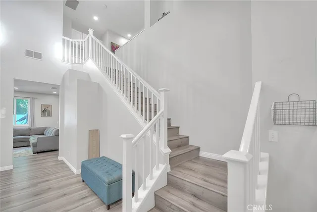 a view of entryway and hall with wooden floor