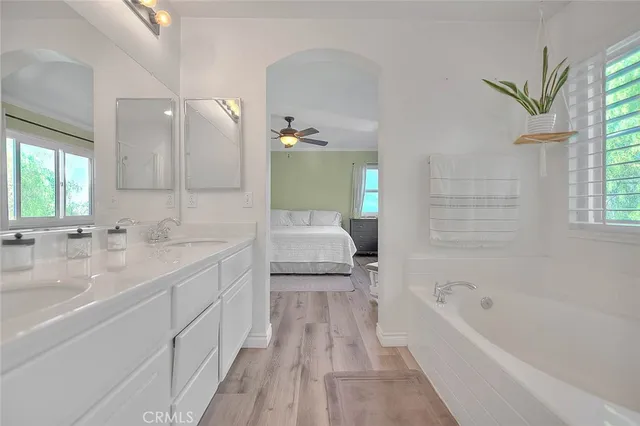 a bathroom with a granite countertop sink a toilet and bathtub