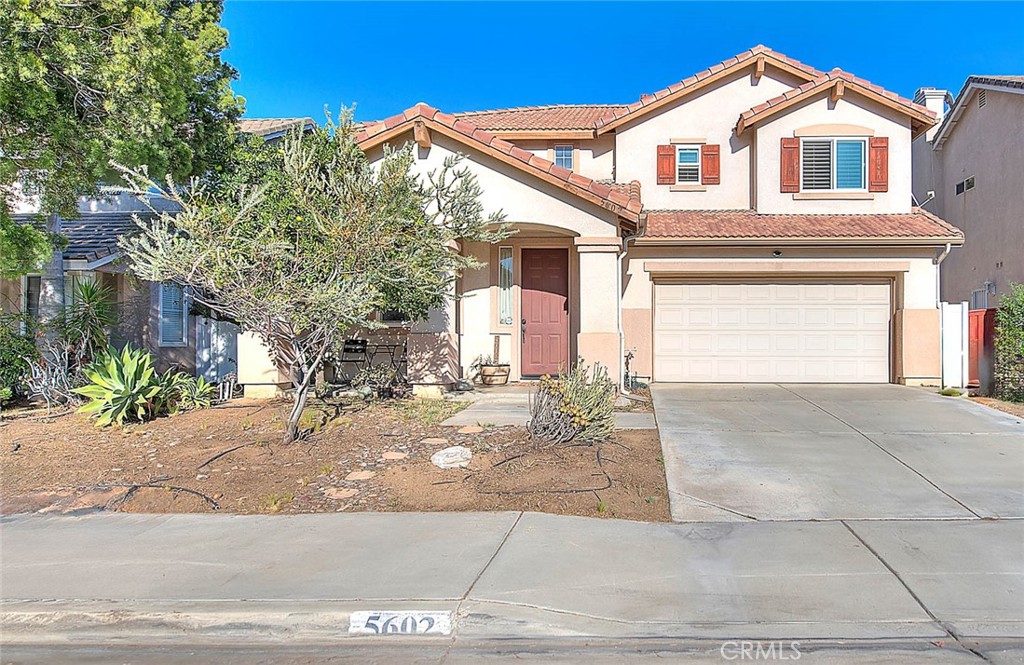 5602 Allendale Drive Riverside, CA 92507 - Photo 4 of 49 a view of a white house with a yard and large tree