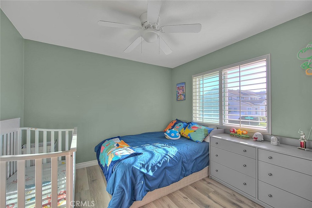 5602 Allendale Drive Riverside, CA 92507 - Photo 42 of 49 a bedroom with a bed and a chandelier