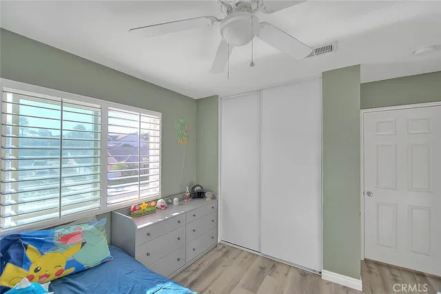 a room with wooden floor and windows