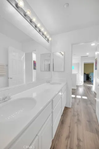 a large white kitchen with a white countertops and fireplace