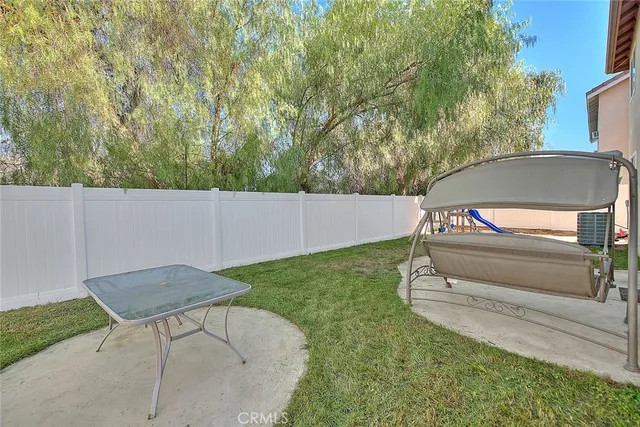 a view of backyard with trampoline