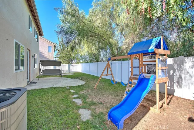 a view of yard with swimming pool and sitting area