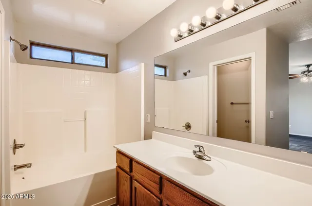 a bathroom with a sink vanity and a mirror