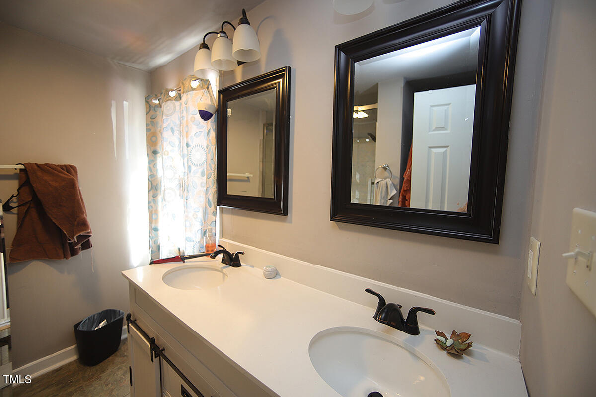 830 Onslow Street Durham, NC 27705 - Photo 2 of 10 a bathroom with a sink and a mirror