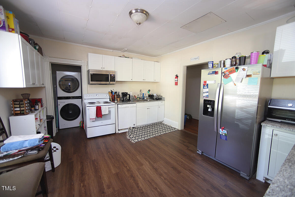 830 Onslow Street Durham, NC 27705 - Photo 3 of 10 a kitchen with stainless steel appliances granite countertop a refrigerator a stove and a microwave with wooden floor