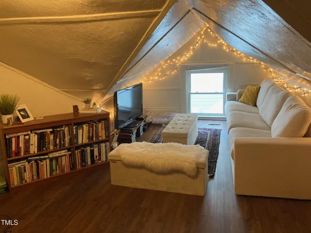 a living room with furniture and a book shelf