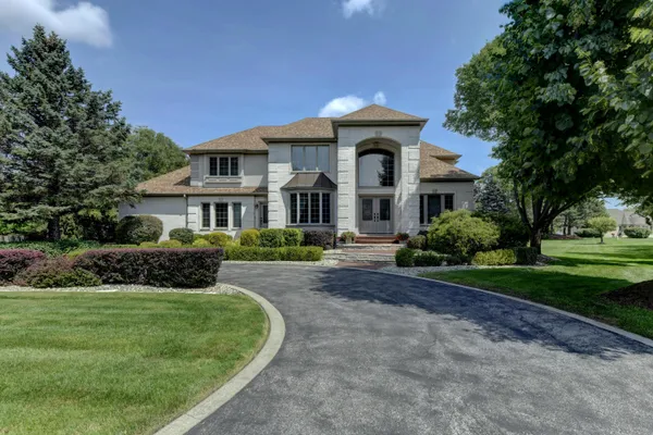 a front view of a house with a yard
