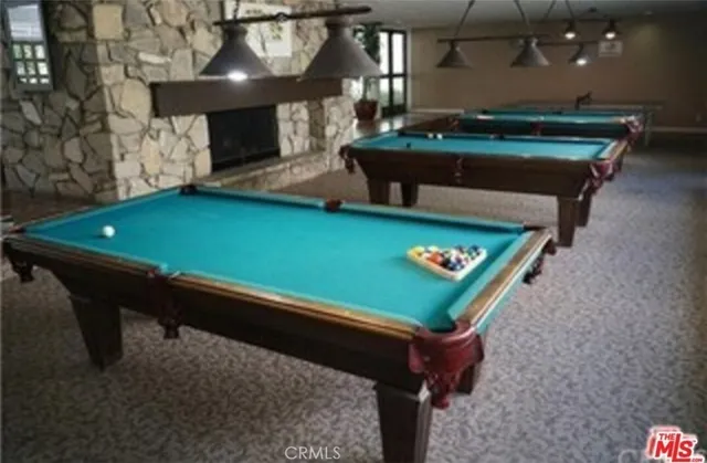 a room with pool table and couches
