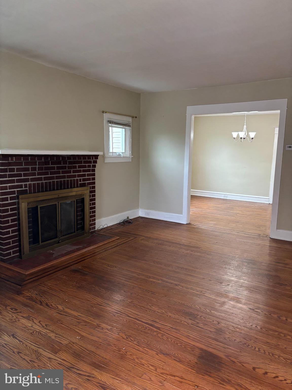 633 Edge Hill Road, Unit 1 Glenside, PA 19038 - Photo 2 of 13 a view of empty room with wooden floor and fireplace