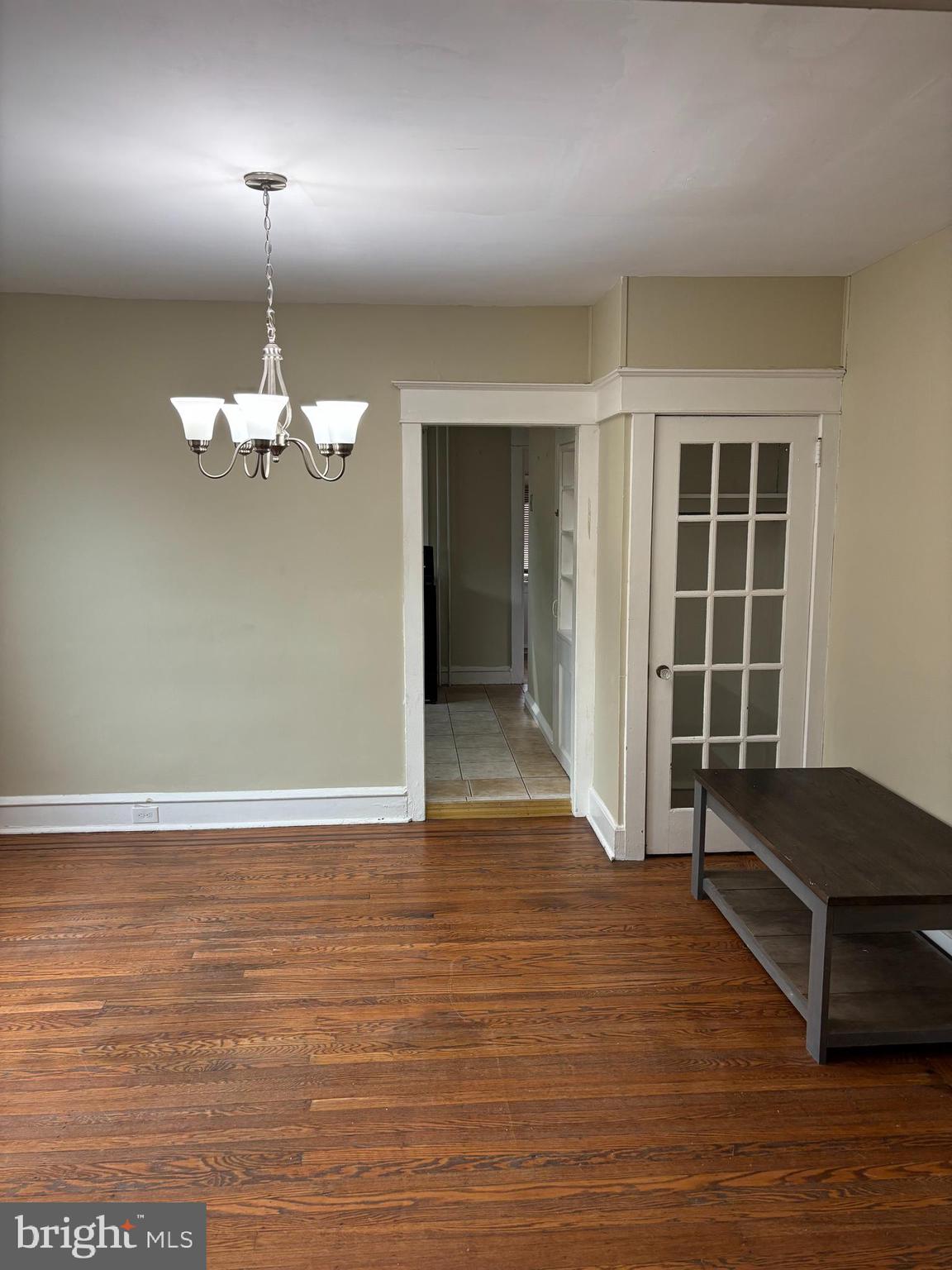 633 Edge Hill Road, Unit 1 Glenside, PA 19038 - Photo 4 of 13 an empty room with wooden floor painted walls and windows