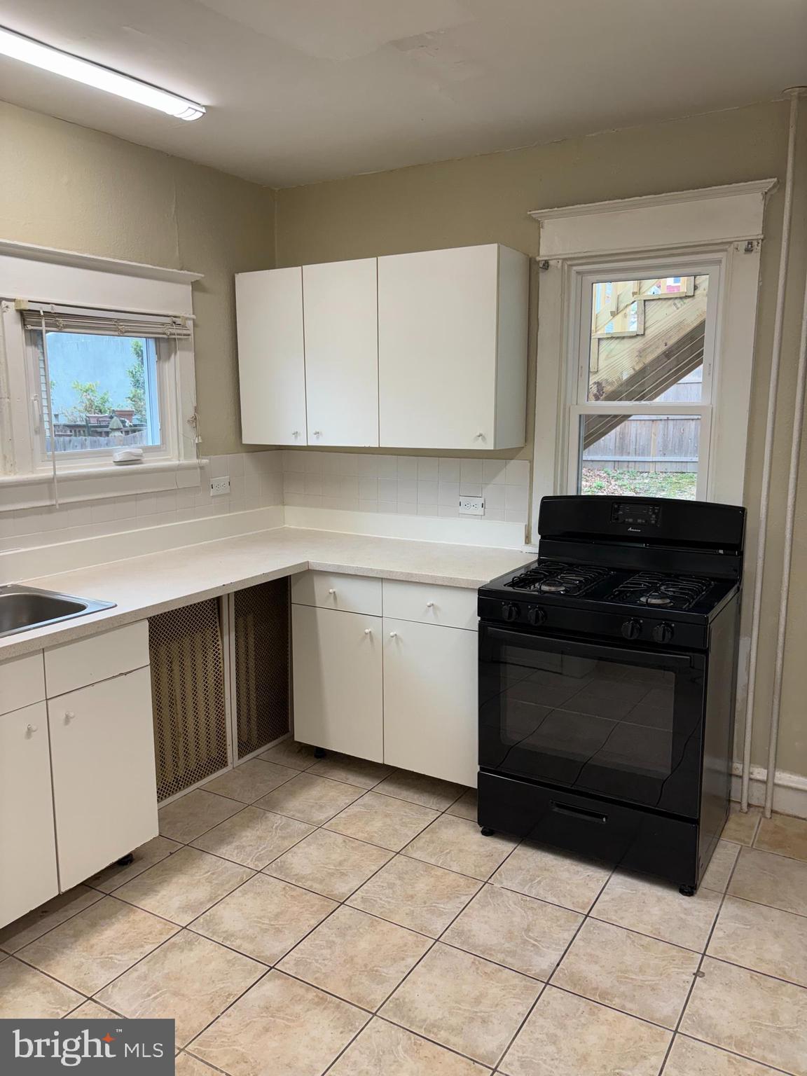 633 Edge Hill Road, Unit 1 Glenside, PA 19038 - Photo 6 of 13 a kitchen with a sink and a stove top oven