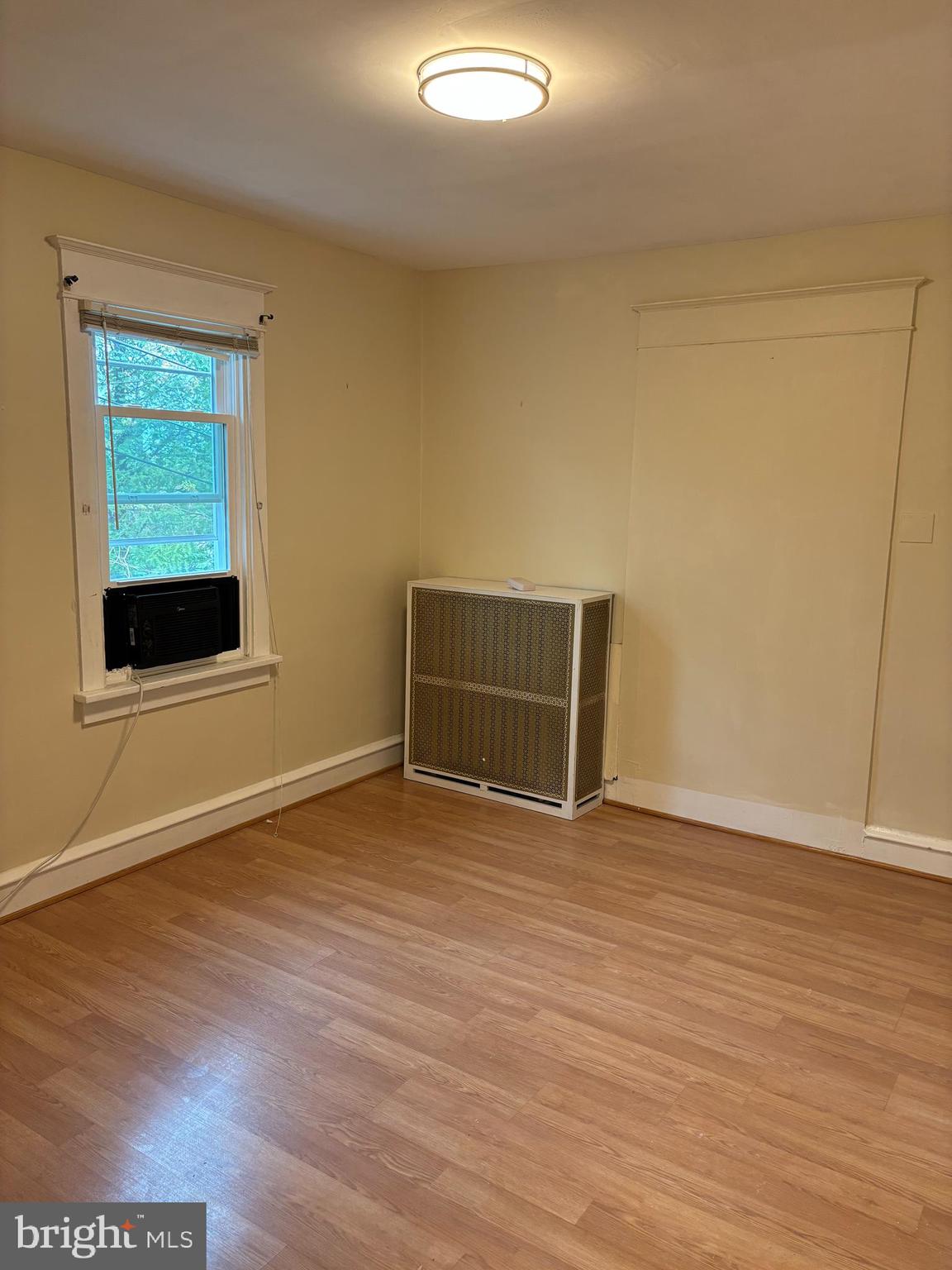 633 Edge Hill Road, Unit 1 Glenside, PA 19038 - Photo 10 of 13 a view of an empty room with wooden floor and a window