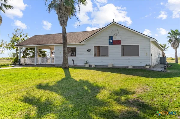 a front view of house with swimming pool and porch