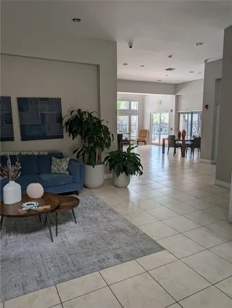 a living room with furniture and potted plants