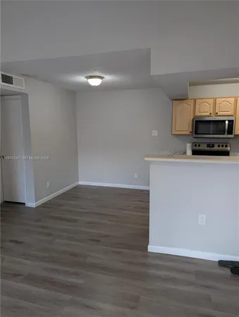 a view of a kitchen with wooden floor