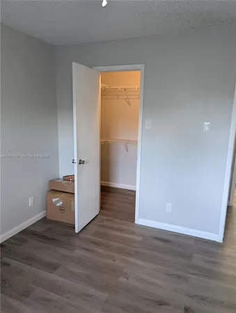 a view of an empty room and wooden floor