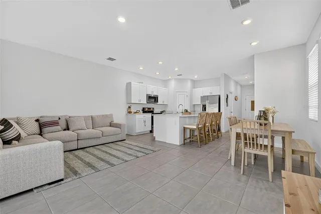 a living room with furniture and a floor to ceiling window