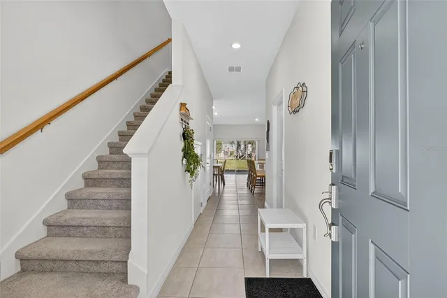 a view of entryway and hall with dining room