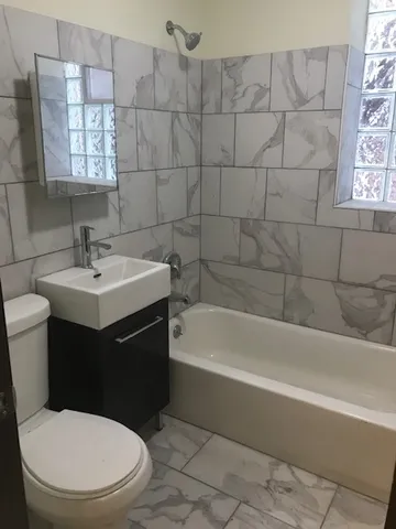 a bathroom with a sink a toilet and bathtub