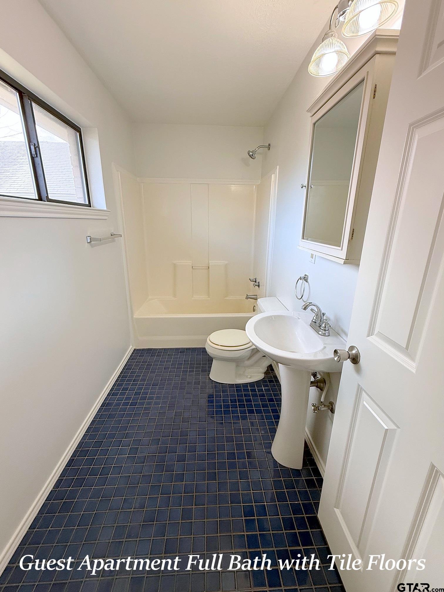 237 Oregon Street Van, TX 75790 - Photo 41 of 44 a bathroom with a sink a toilet a mirror and vanity