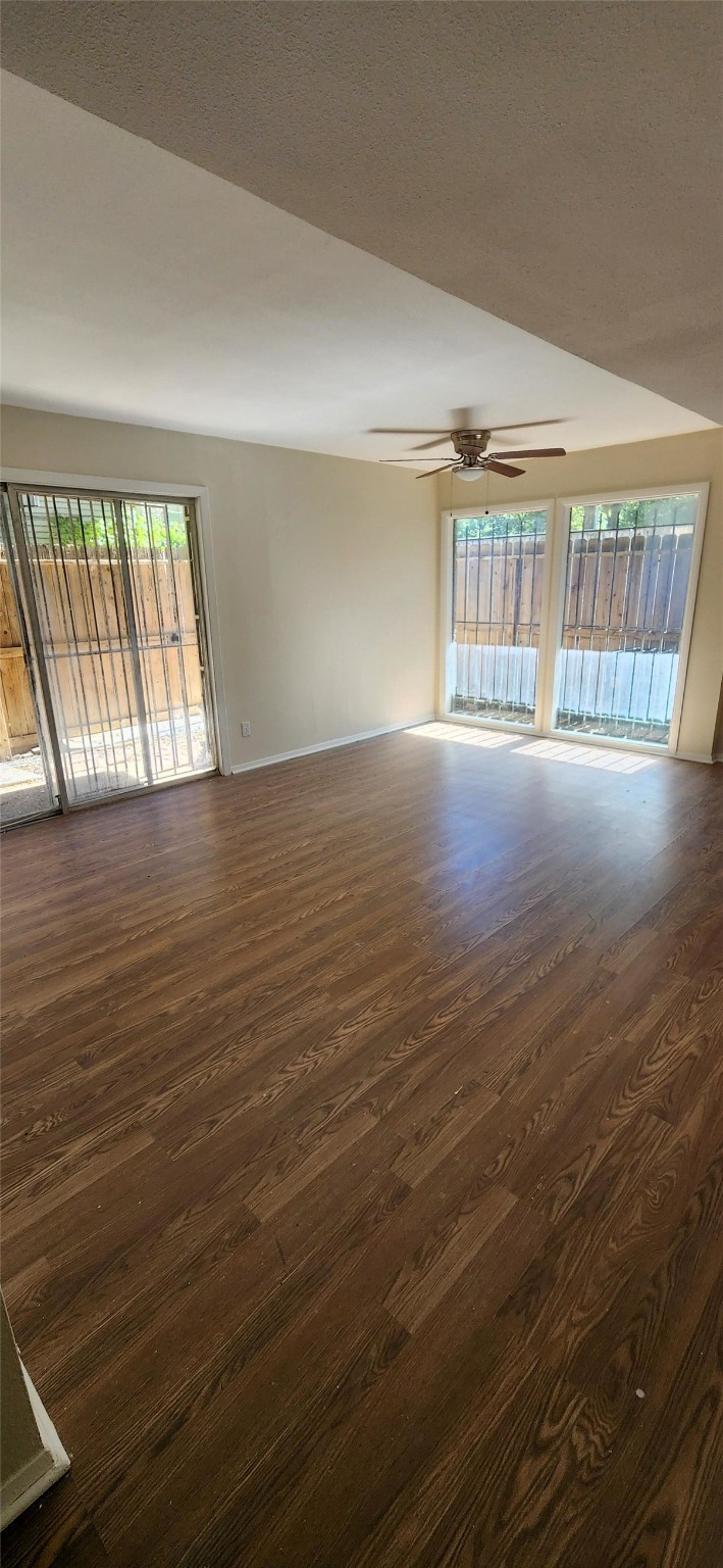 909 Silber Road, Unit 27E Houston, TX 77024 - Photo 11 of 15 wooden floor in an empty room with a window