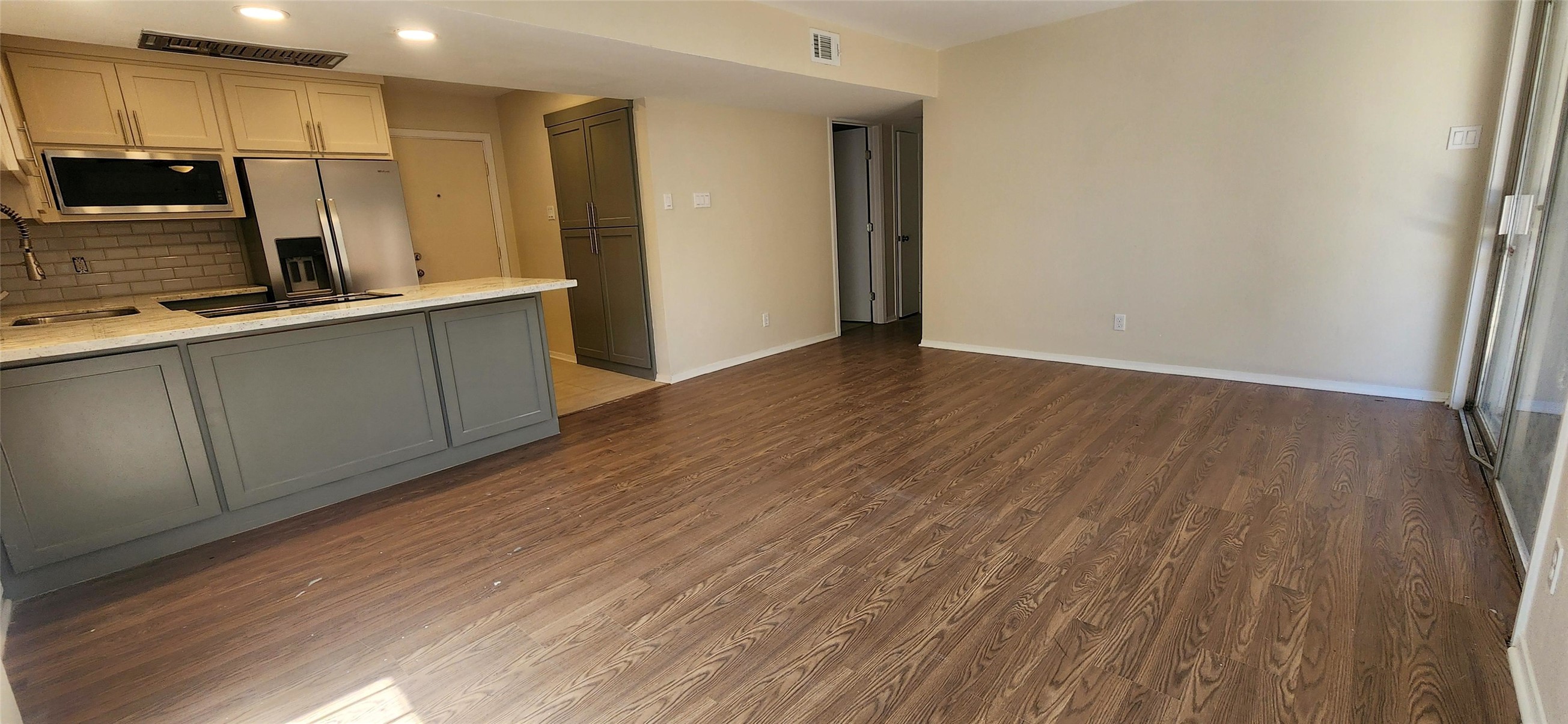 909 Silber Road, Unit 27E Houston, TX 77024 - Photo 2 of 15 a kitchen with stainless steel appliances granite countertop a refrigerator and a sink