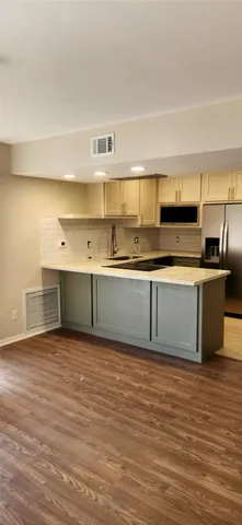a kitchen with stainless steel appliances granite countertop a sink and a stove top oven