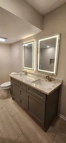 a bathroom with a double vanity sink and a mirror