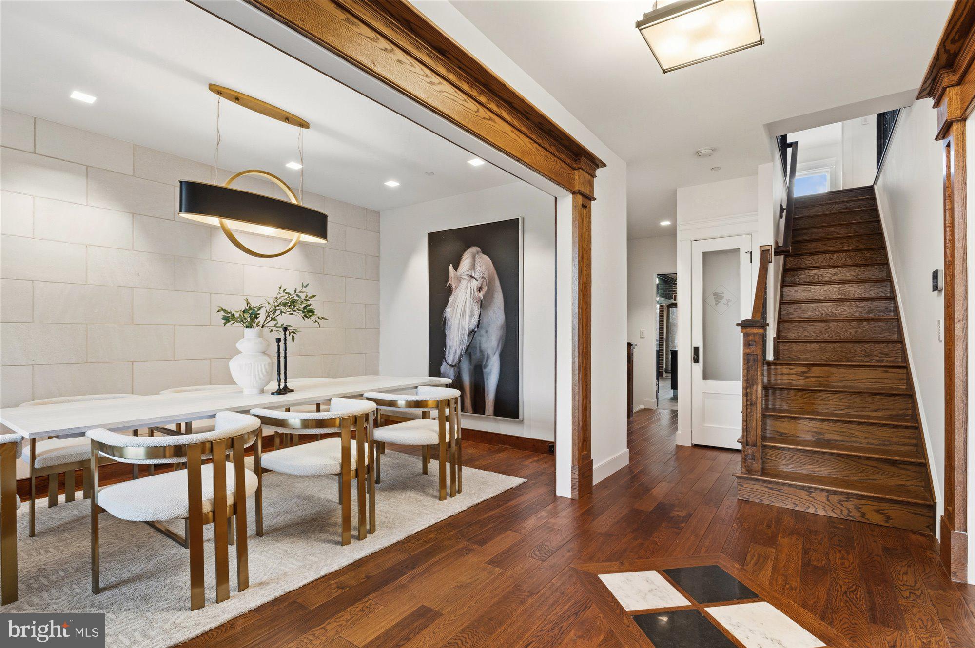 a view of a hallway with furniture and wooden floor