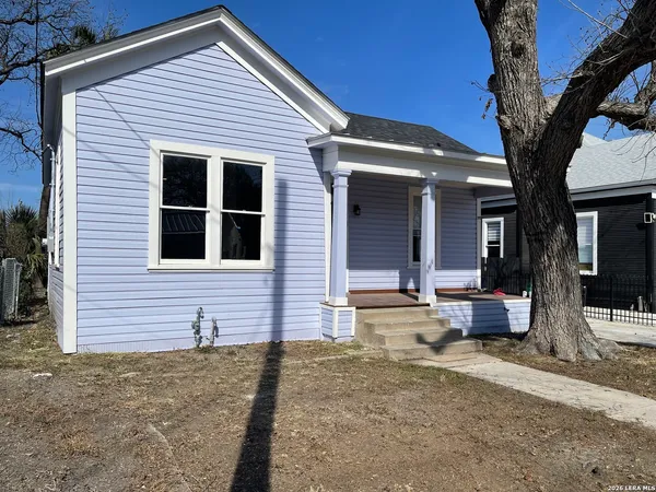 a front view of a house with outdoor seating