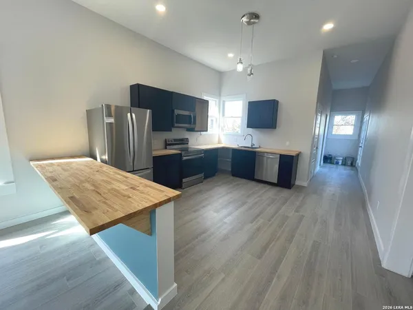 a kitchen with stainless steel appliances kitchen island a refrigerator sink and microwave