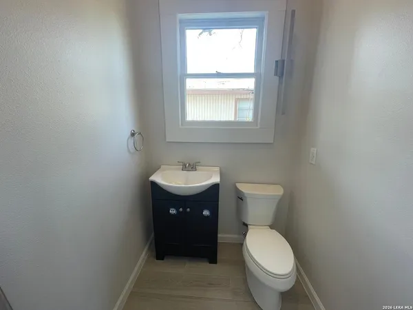 a bathroom with a toilet sink and mirror