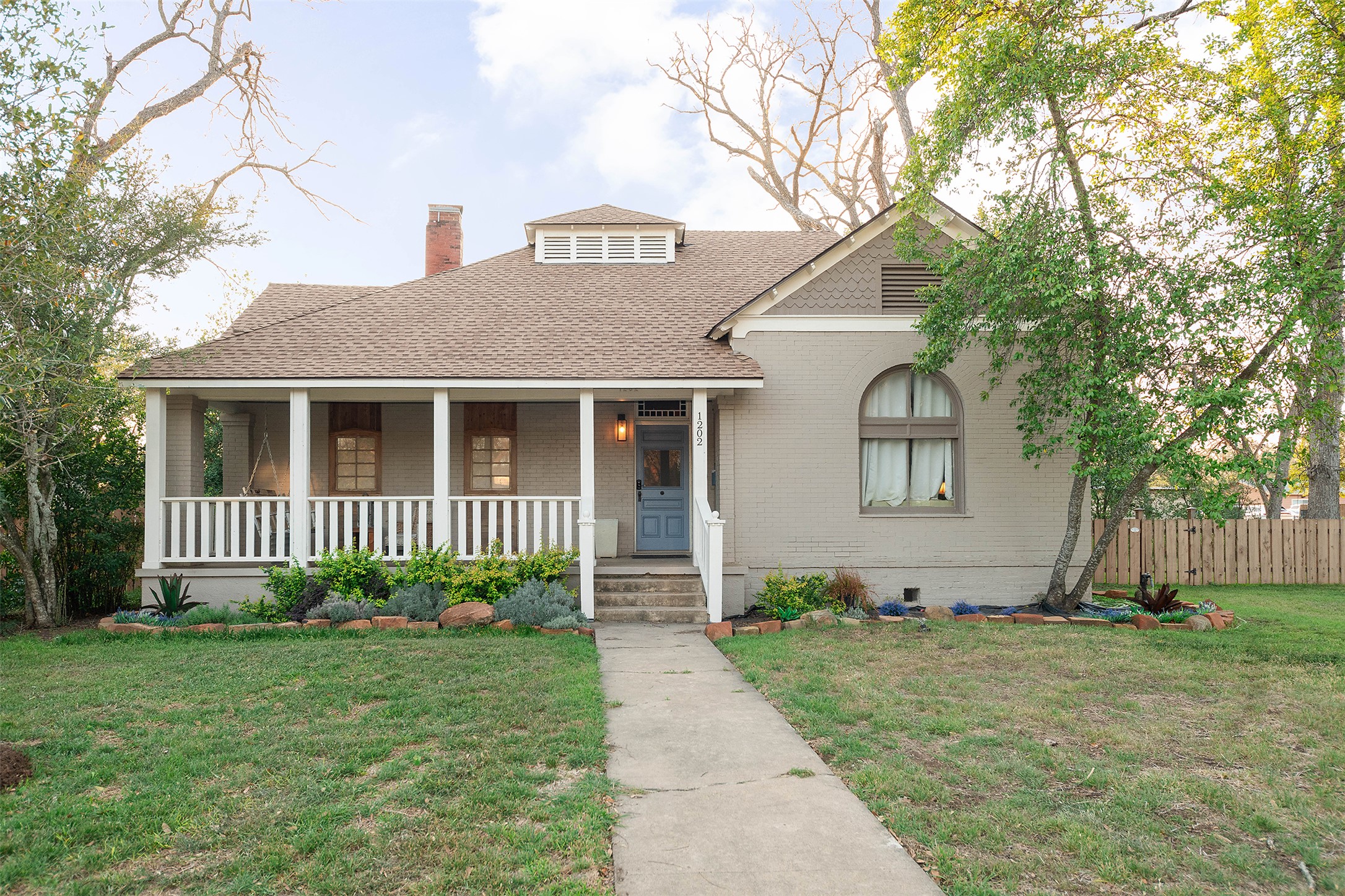 1202 Pecan Street Bastrop, TX 78602 - Photo 35 of 38 a front view of a house with a garden