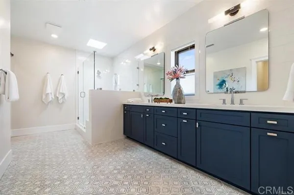 a bathroom with a shower and a sink