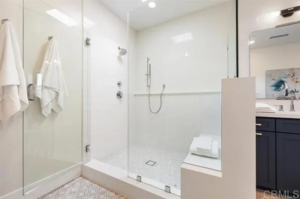 a bathroom with a double vanity sink and mirror