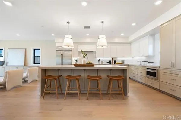 a kitchen with a sink and chairs