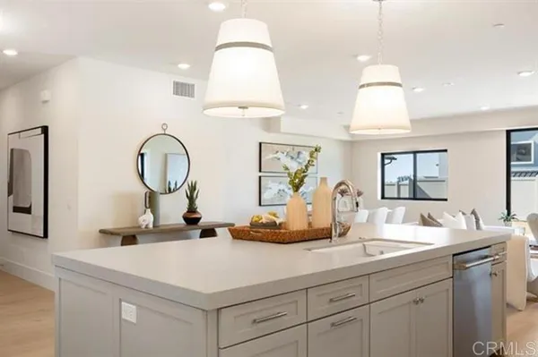 a kitchen with cabinets a sink and a chandelier