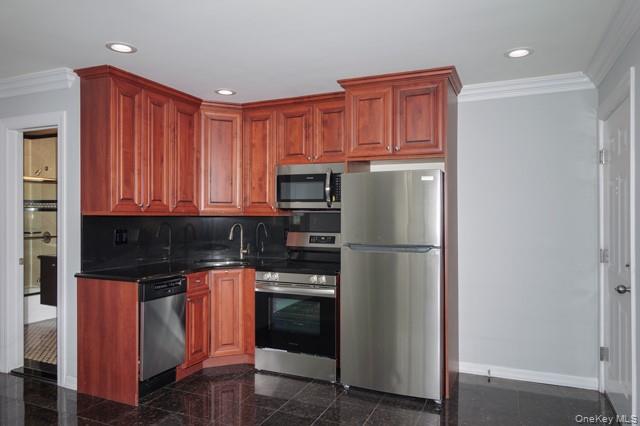 118 Carleton Avenue, Unit 6B Islip Terrace, NY 11752 - Photo 3 of 9 a kitchen with stainless steel appliances granite countertop a refrigerator and a stove top oven