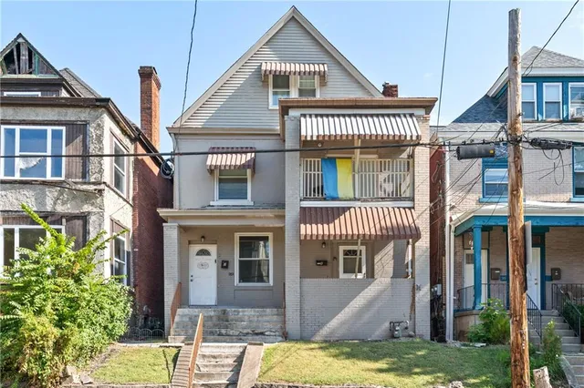 a front view of a house with a yard