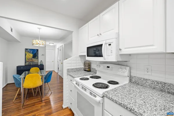 a kitchen with a stove a sink and a microwave