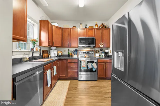 a kitchen with stainless steel appliances a refrigerator sink and cabinets