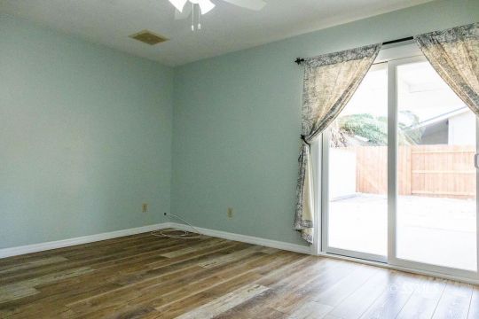 1012 Conejo Avenue Ridgecrest, CA 93555 - Photo 10 of 24 a view of empty room with wooden floor and fan