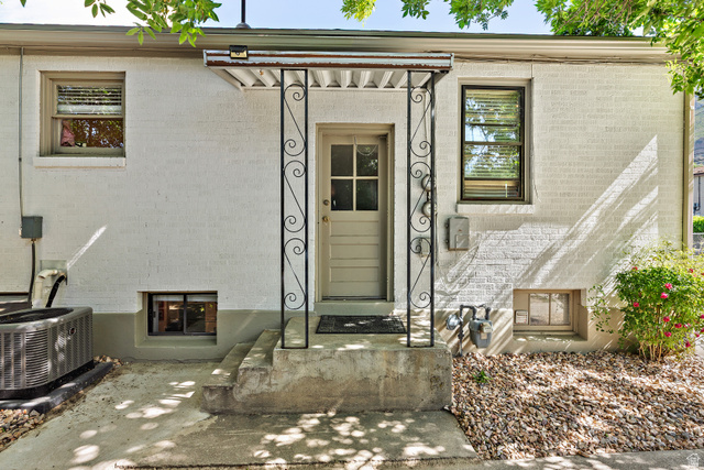 372 800 East Provo, UT 84606 - Photo 26 of 29 White brick exterior featuring a covered entry with decorative wrought iron supports
