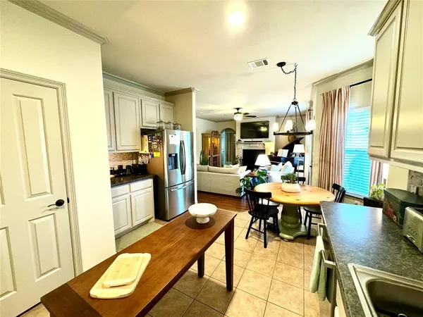 a living room with stainless steel appliances kitchen island granite countertop furniture and a view of kitchen