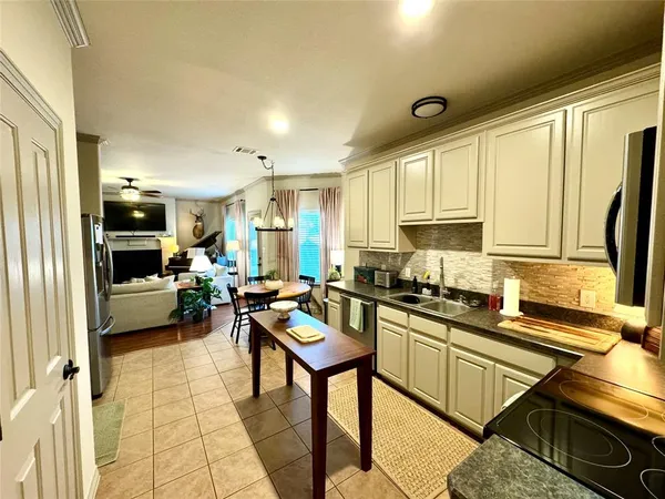 a kitchen with counter top space a sink and appliances