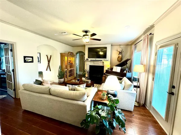 a living room with furniture a fireplace and a flat screen tv